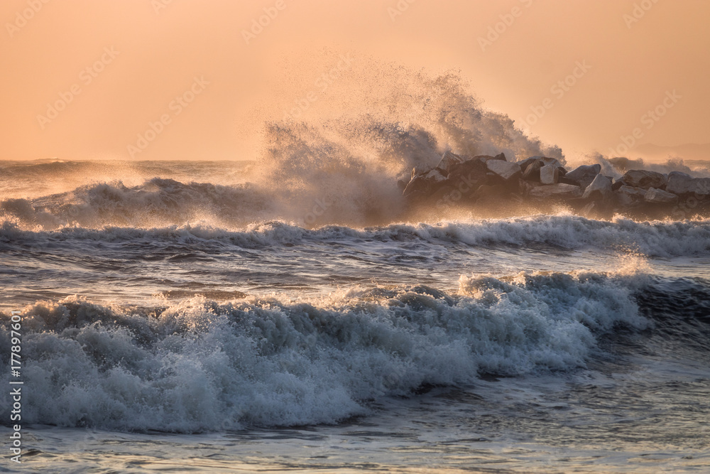 Fototapeta premium Sea waves crashing on a rocky pier, Italy, Tuscany