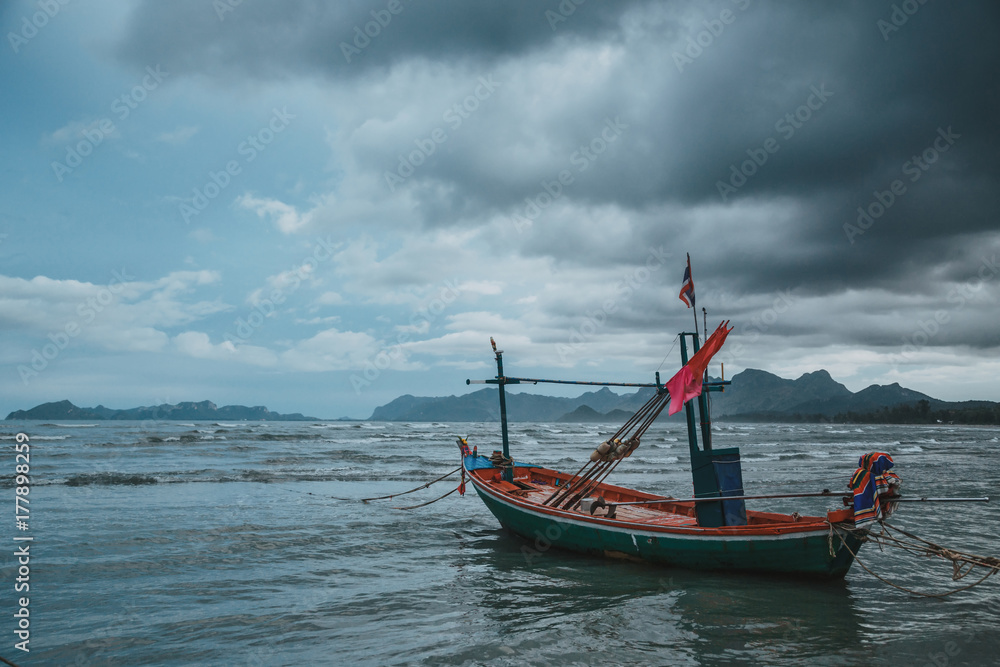 Coastal fishing boats at low tide in summer of Thailand