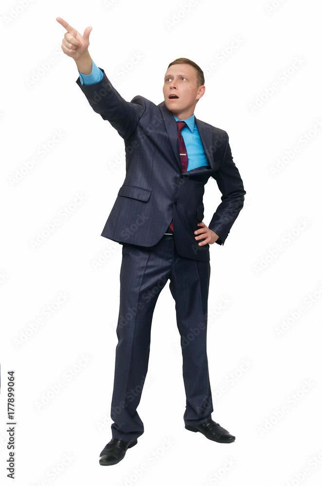 Shocked business man showing by his index finger on something in front of him with wide open mouth isolated on white background.