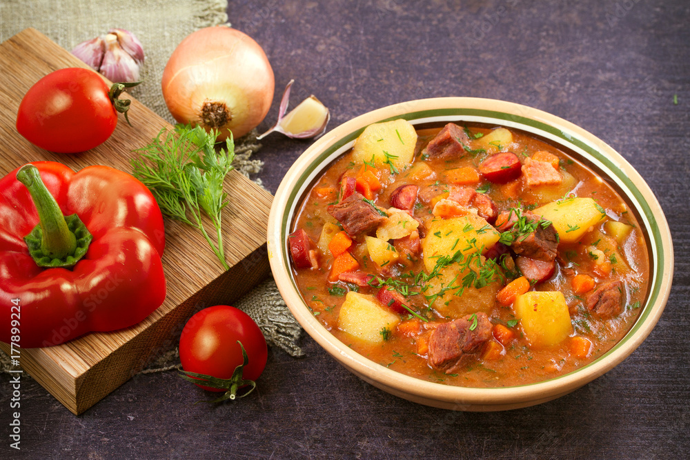 Tasty stew. Goulash soup bograch in a bowl and ingredients. Hungarian dish, horizontal Tasty stew. Goulash soup bograch in a bowl and ingredients. Hungarian dish, horizontal