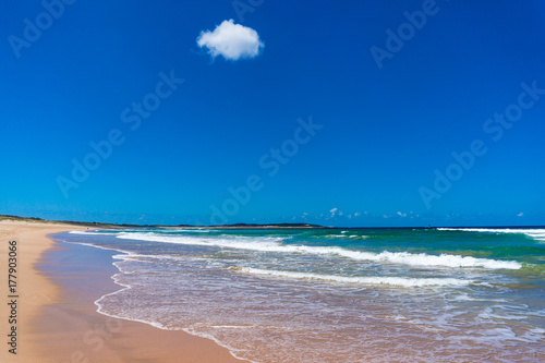 Beach shore with sand and mild waves