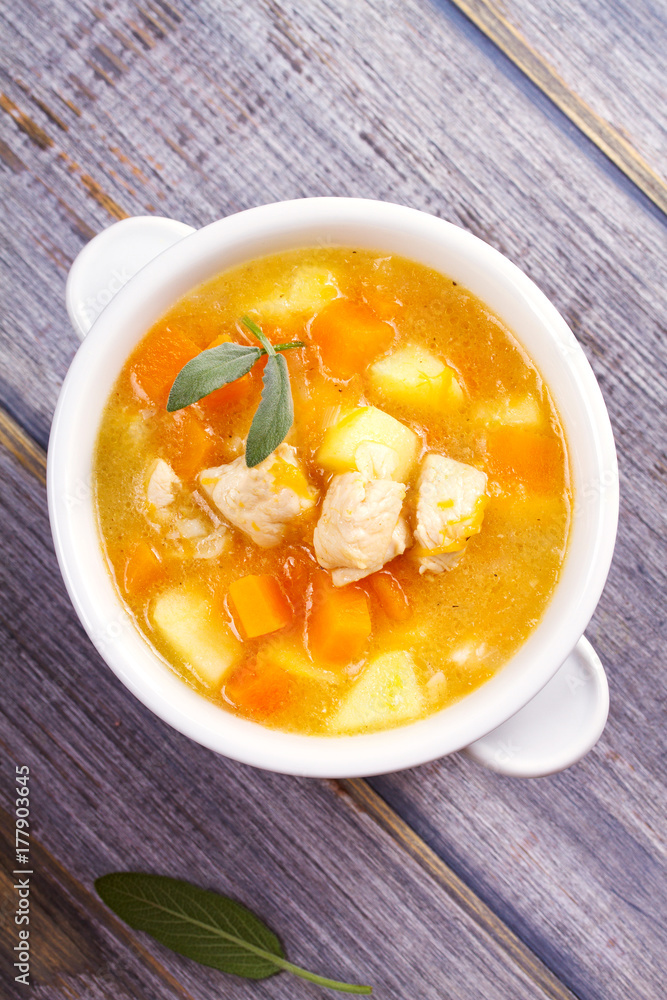 Chicken, butternut, apple ginger and sage stew. Pumpkin and chicken breast soup. View from above, top shot, vertical Chicken, butternut, apple ginger and sage stew. Pumpkin and chicken breast soup. View from above, top shot, vertical