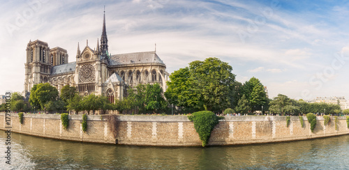 Notre Dame de Paris, France, at daytime. Summer travel background. Scenic cityscape with dramatic sky.
