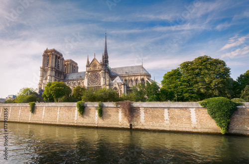 Notre Dame de Paris, France, at daytime. Summer travel background. Scenic cityscape with dramatic sky.