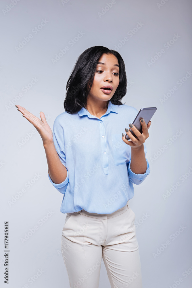 Surprised young woman reading text message Surprised young woman reading text message