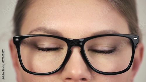 Macro footage of female eyes blinking wearing eyeglasses. Concept of vision correction and eye care. 