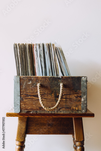 Vintage record collection in an old wooden box, sitting on an antique table photo