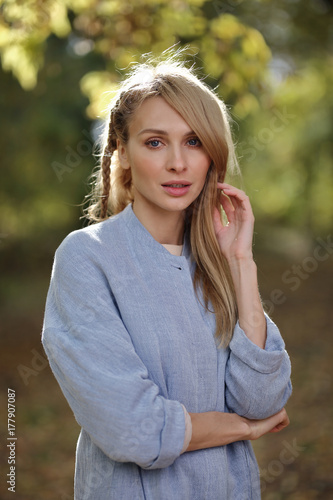 Fashion portrait of beautiful blonde woman in stylish clothes in autumn park.