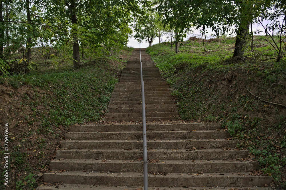 Concrete stairs going up to top of the hill