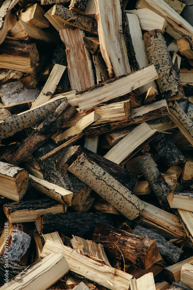 Firewood background - chopped firewood on a stack Firewood background - chopped firewood on a stack