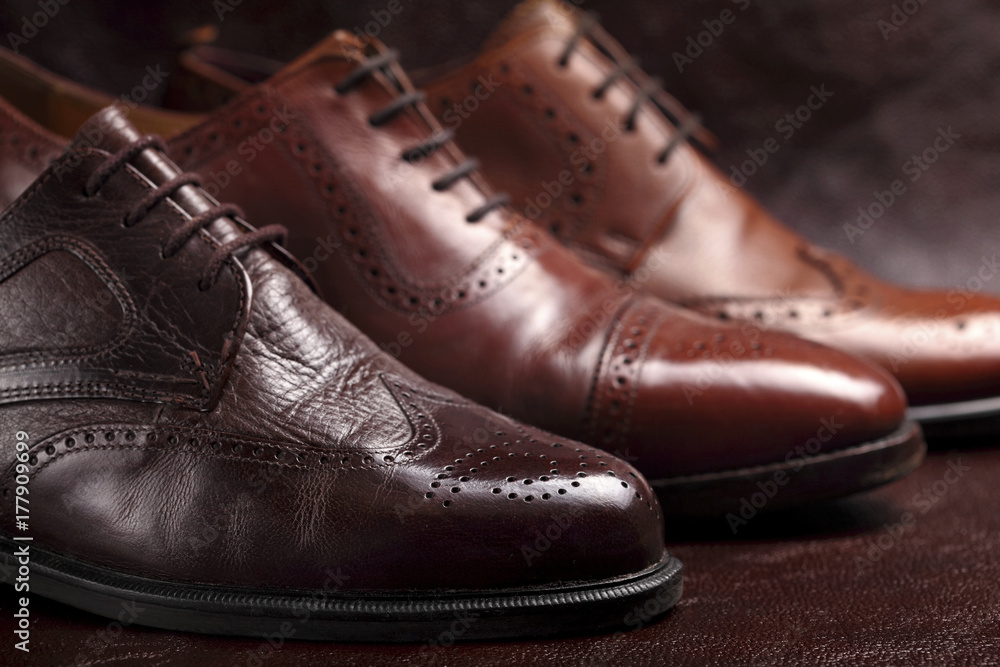 Fashion classical polished men's brown oxford brogues on leather background.Selective focus
