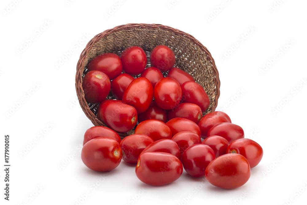 Red tomatoes in a basket on a white background Red tomatoes in a basket on a white background