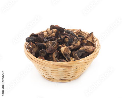 Dried mushrooms in a basket on a white background