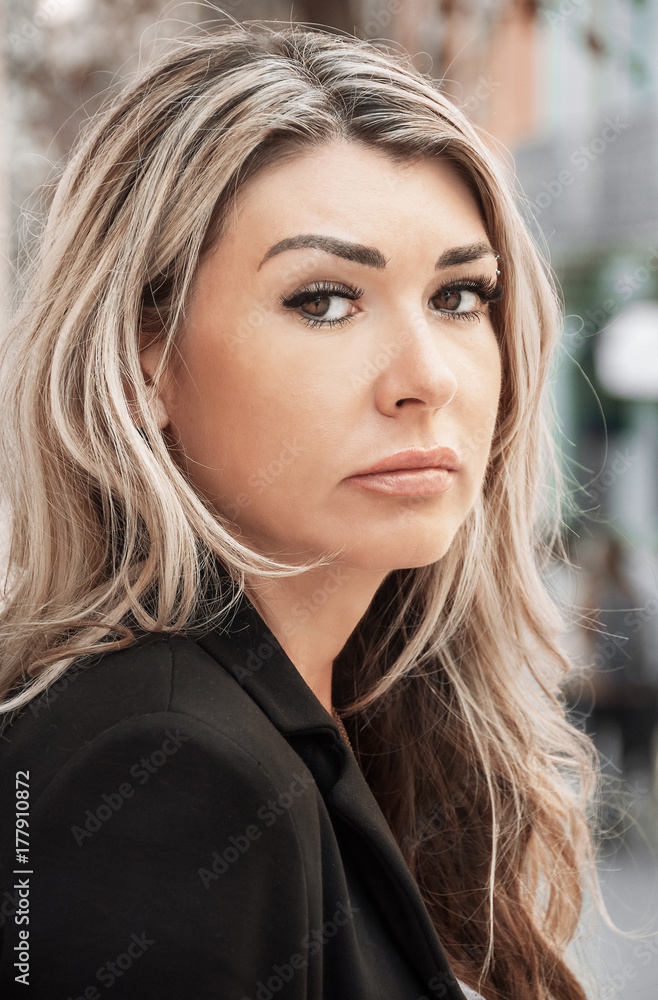 Portrait of business girl close-up, dressed in a business suit, jacket. Serious look with suspicion. Portrait of business girl close-up, dressed in a business suit, jacket. Serious look with suspicion.