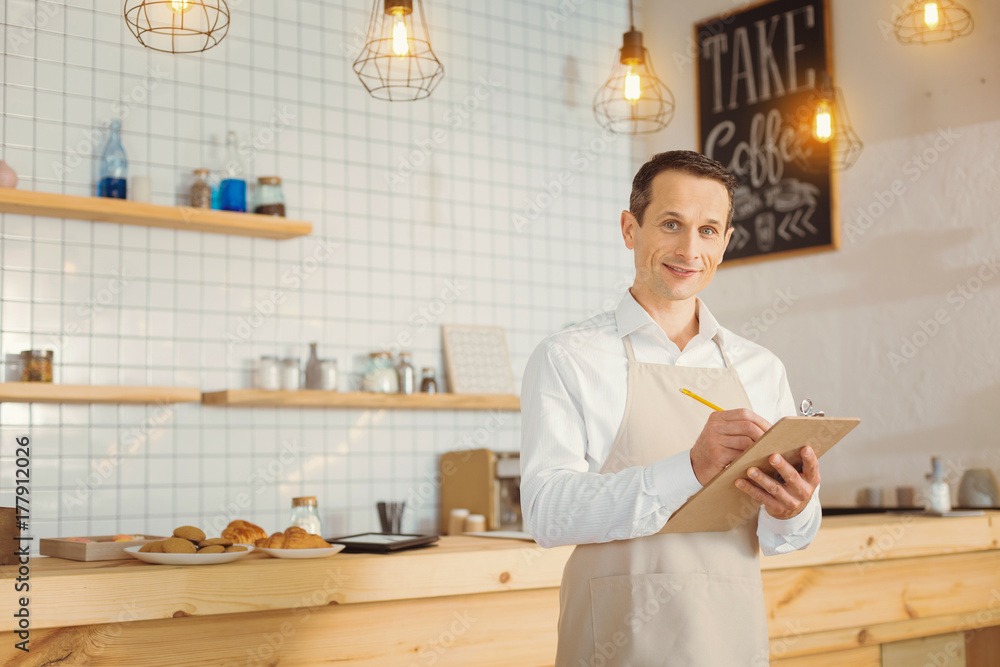 Fotografie Smart pleasant man working in the bakery