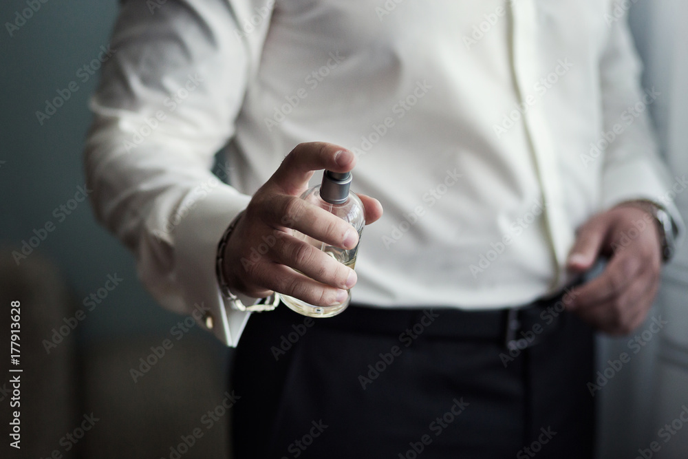 Handsome guy is choosing perfumes,Rich man prefers expensive cologne,Elegant man in suit using cologne or perfume,Male perfume,Successful businessman likes perfume scent Handsome guy is choosing perfumes,Rich man prefers expensive cologne,Elegant man in suit using cologne or perfume,Male perfume,Successful businessman likes perfume scent