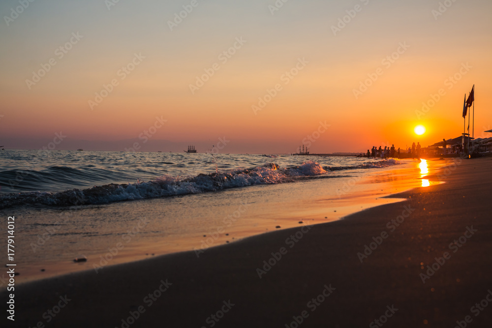 People on the beach under sunset sunlight