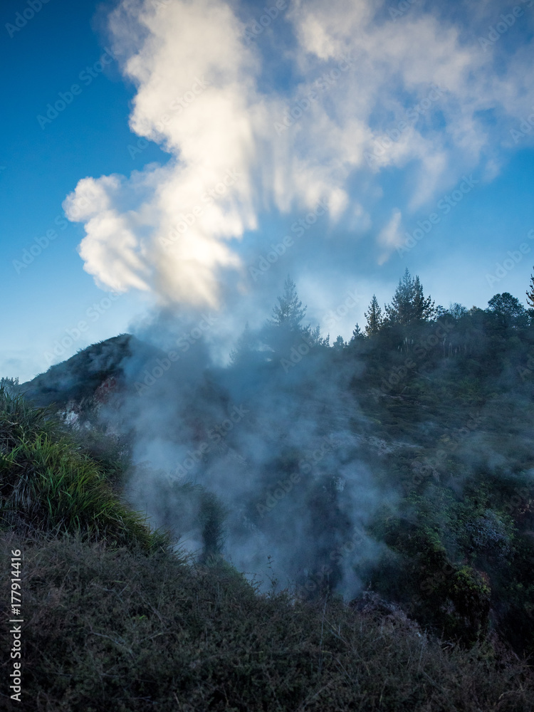 Geothermal steam fissure with sunlight shining through steam