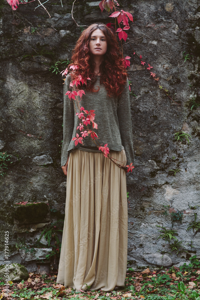 Young beautiful woman with red hair in autumn Young beautiful woman with red hair in autumn