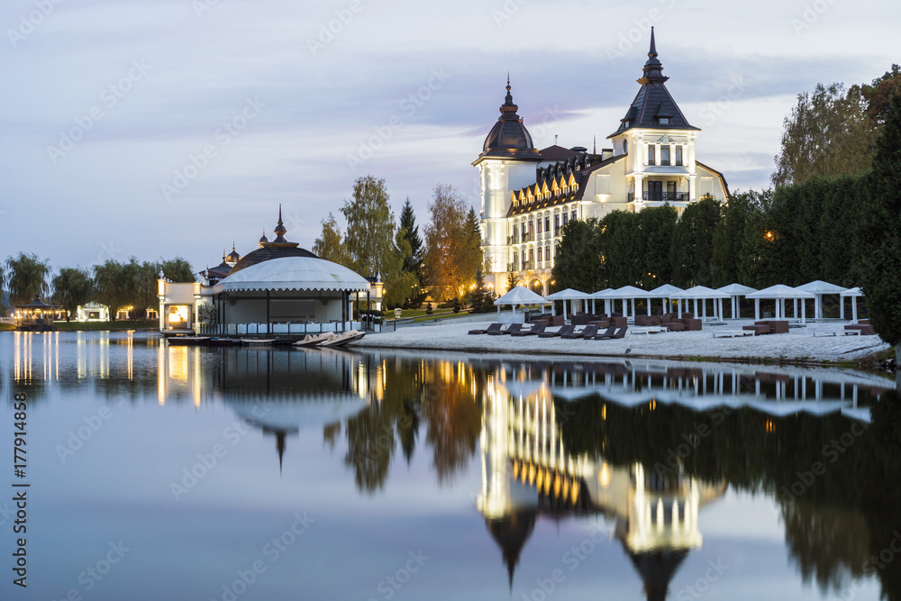 Evening facade of the tourist complex against the background of the lake Evening facade of the tourist complex against the background of the lake
