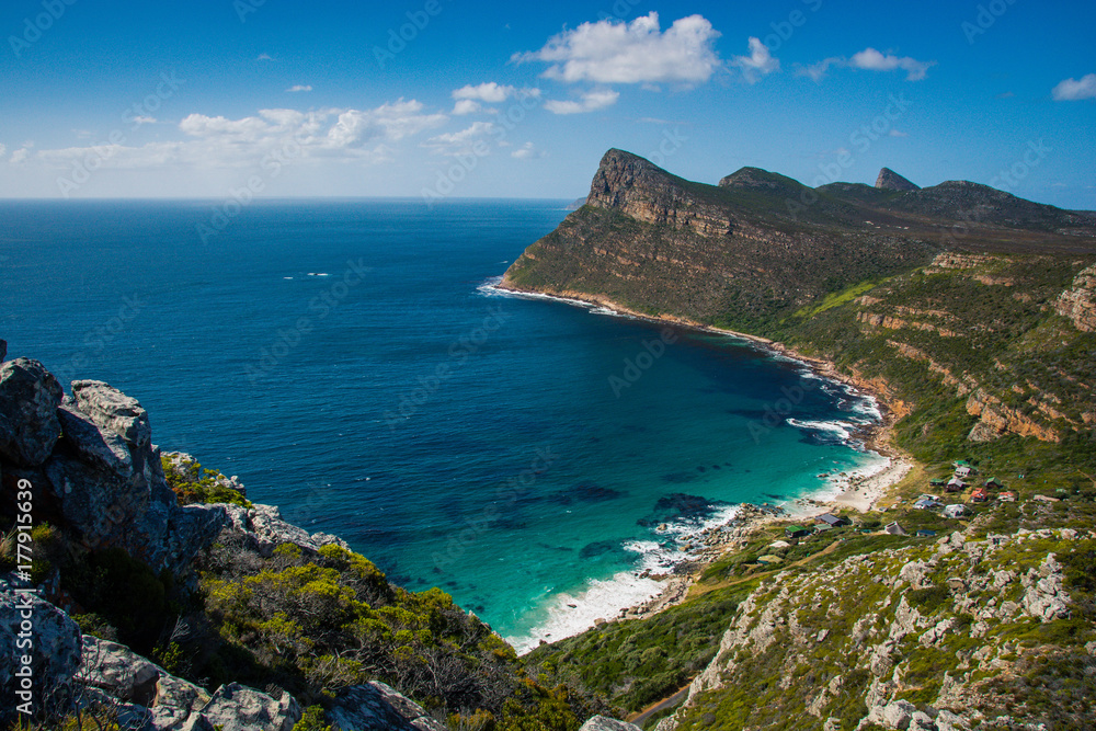View from a mountain onto the clear blue water of Smitswinkel Bay, near Cape Point, South Africa