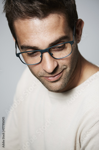 Handsome dude in spectacles looking down, close up © sanneberg