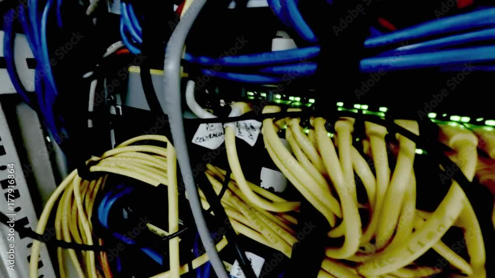 The blinking led lights of a network server panel, switch and patch
