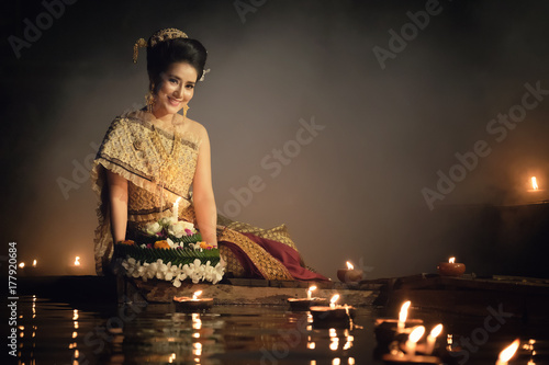 Loy Krathong Traditional Festival, Thai woman hold kratong, Thailand, Asia woman in Thai dress traditional hold kratong and bring Krathong to float in Loi kratong day of Thailand. photo