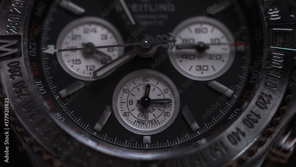 Closeup view of luxury man's wristwatch. Detail of a luxury watch on black background. Selective focus, shallow depth of field. Man's wristwatch macro