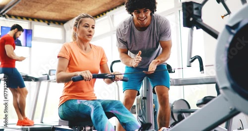 Young beautiful woman doing exercises with personal trainer