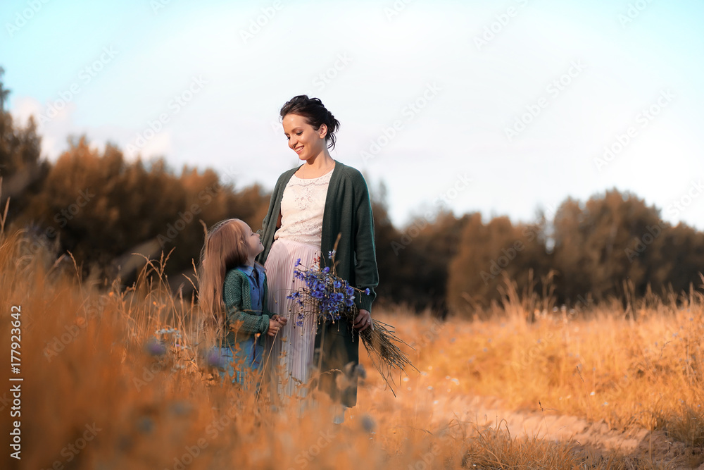 Mother with daughter walking on a road Mother with daughter walking on a road