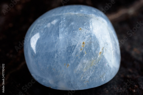 Lovely blue polished calcite nugget on black stone slate.