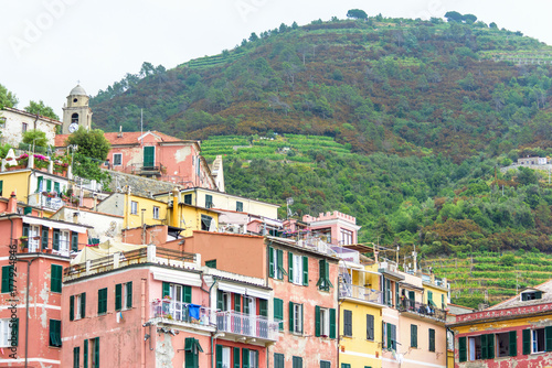 View to old houses and mountains with vineyards in Vernazza, Cinque Terre, Italy. © frimufilms