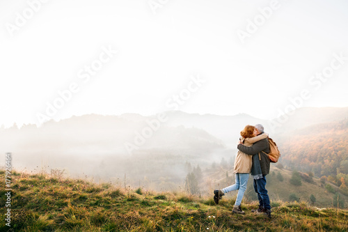 Senior couple on a walk in an autumn nature.