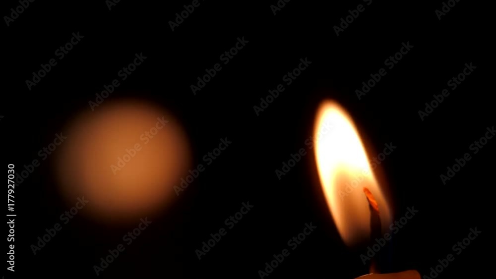 Close-up of a candle flame on a black background. Close-up of a candle flame on a black background.