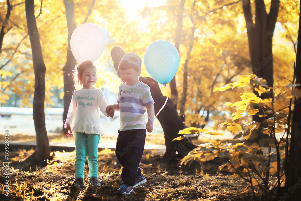 Fototapeta premium Little children are walking in autumn park