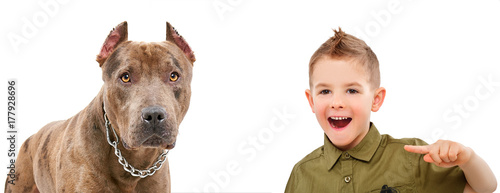 Obraz na plátně Portrait of laughing boy, pointing finger on a dog, isolated on a white backgrou
