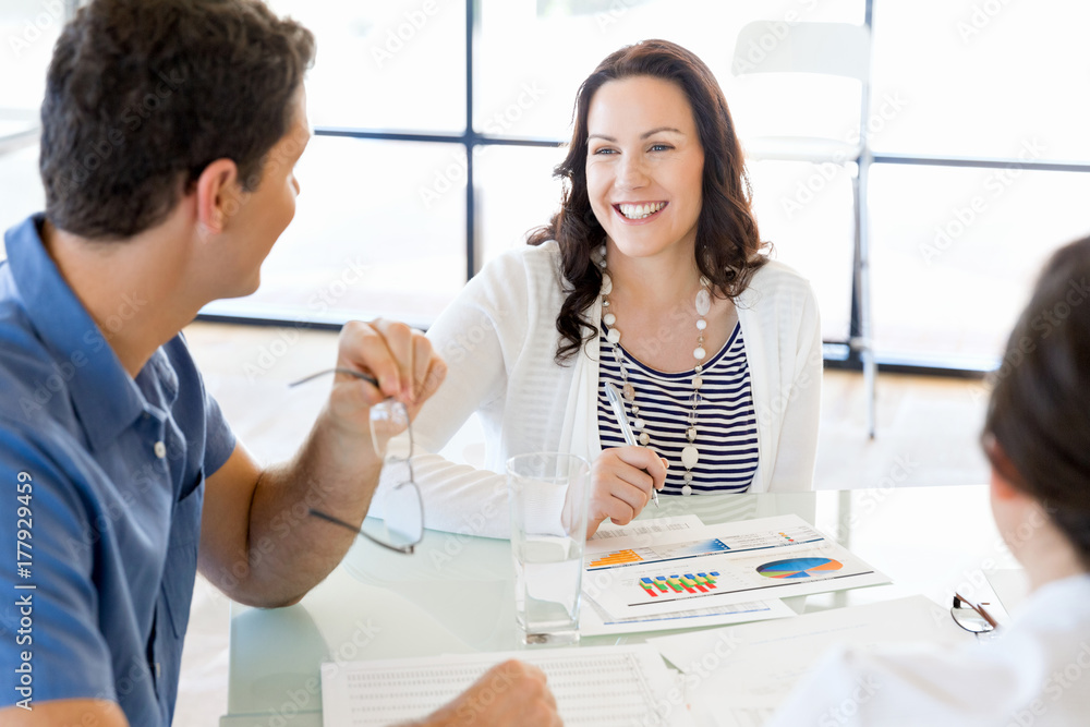 Image of business partners discussing documents and ideas