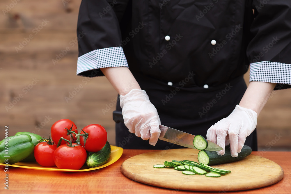 The cook cuts fresh farm vegetables The cook cuts fresh farm vegetables