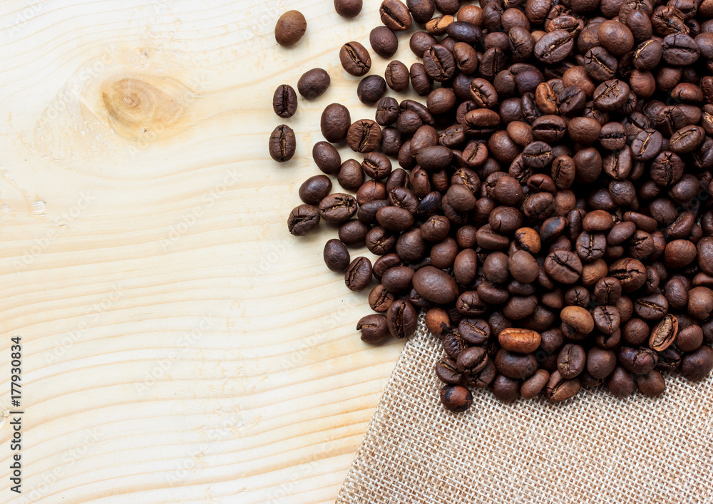 Fototapeta premium Roasted coffee beans on wooden background