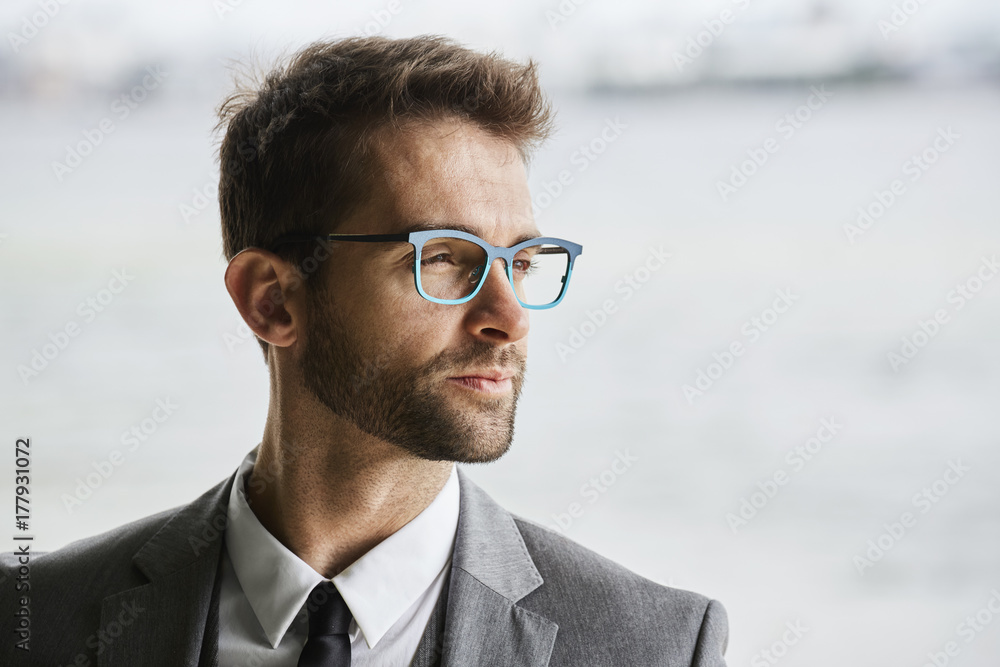 Glasses business guy in smart suit looking away Stock Photo