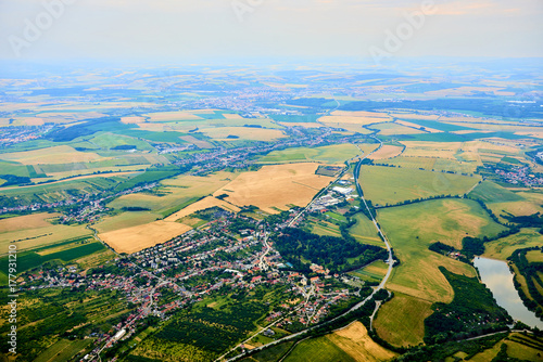 Aerial view of unidentified village in summer countryside during sunset. © Petr Bonek