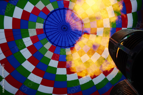 A burner with its super hot flame light up inside of a hot air balloon as it is inflated for an  flight.