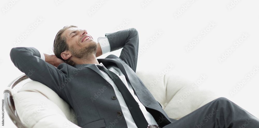 young businessman meditating in big comfortable armchair young businessman meditating in big comfortable armchair