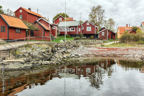 Typical Swedish fishing village with red wooden houses. photo