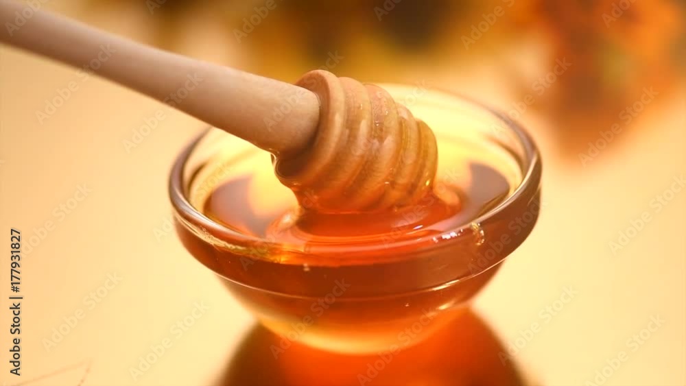 Healthy organic thick honey dripping from wooden stick. Slow motion 4K UHD video 3840x2160 Healthy organic thick honey dripping from wooden stick. Slow motion 4K UHD video 3840x2160