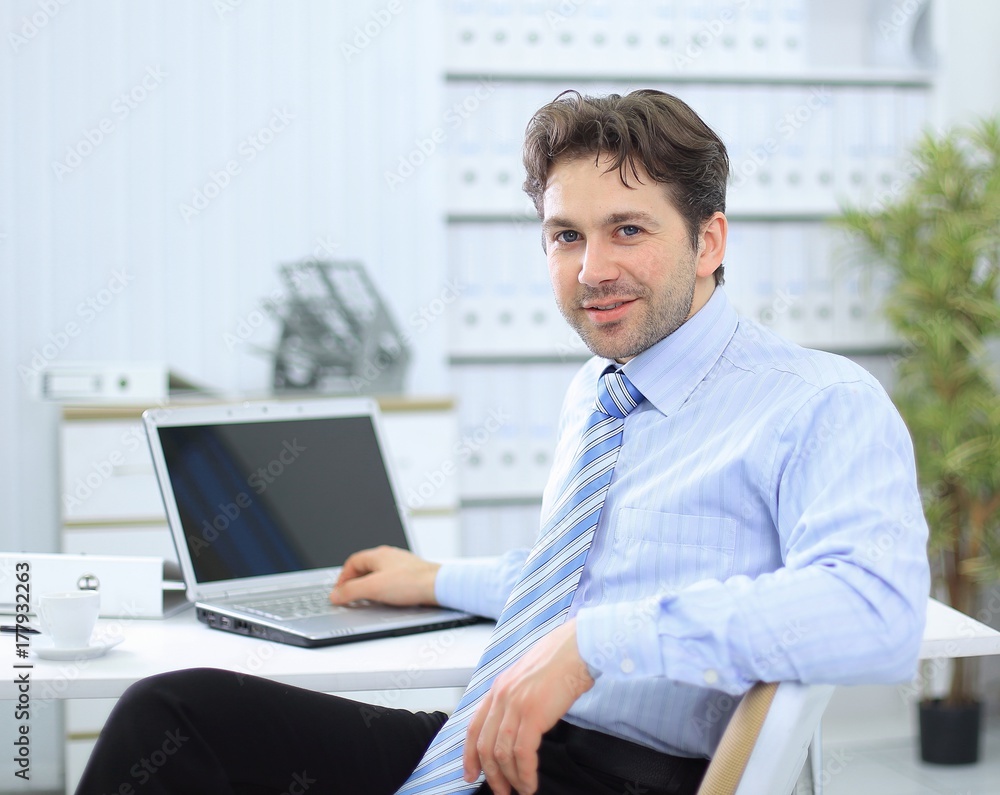 closeup.handsome businessman sitting in this Desk closeup.handsome businessman sitting in this Desk
