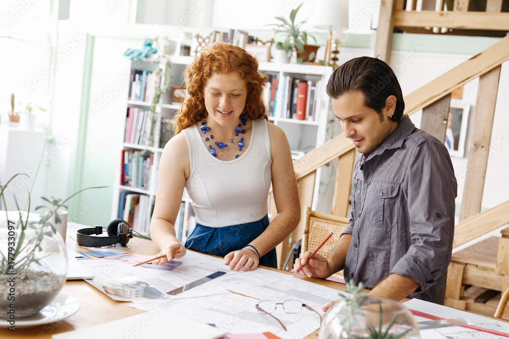 Fototapeta premium Two young architects in office