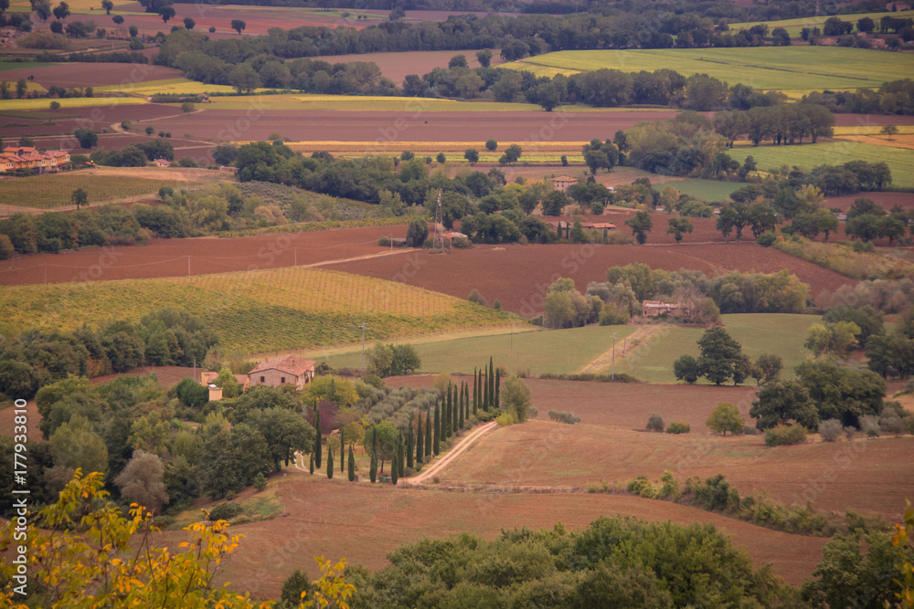 A farming scene in Umbria, Italy.  Farmhouses, orchards and fields