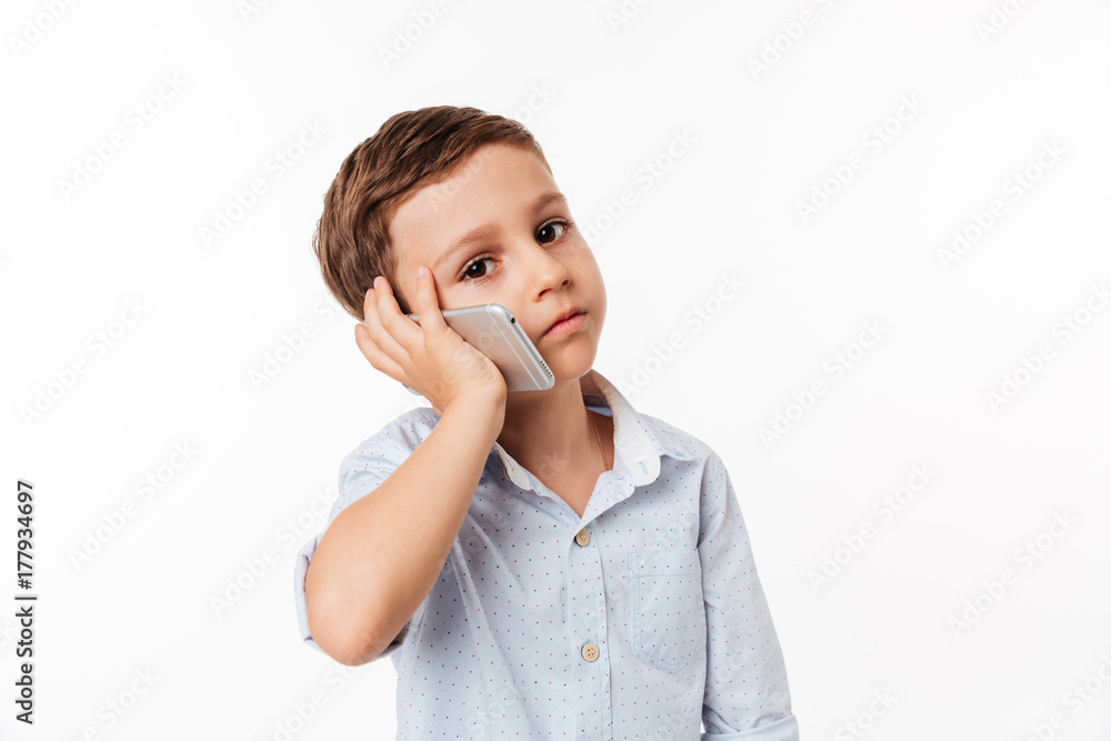 Portrait of a cute little kid talking on mobile phone Portrait of a cute little kid talking on mobile phone